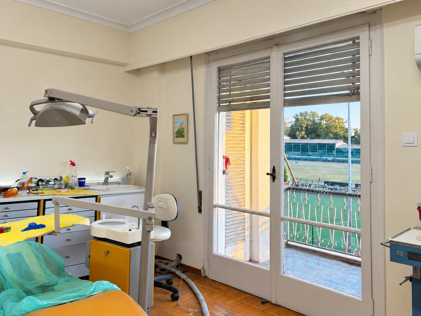 Dental chair and light beside the sunlit balcony